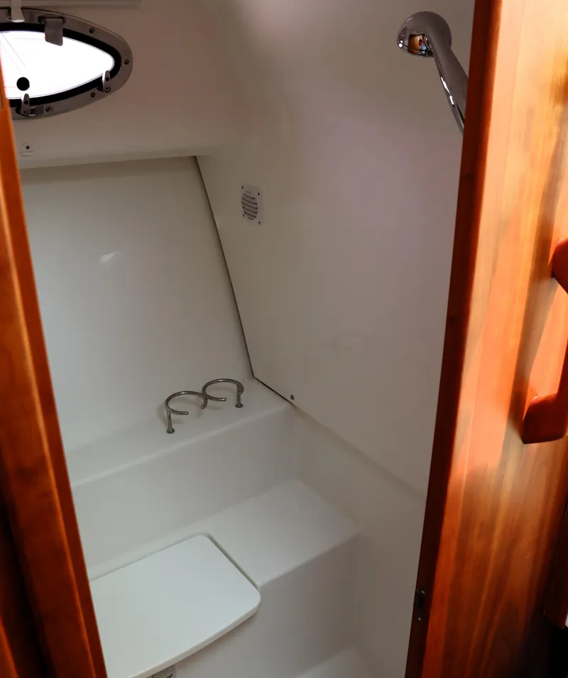 Slide: The Image of 2020 Back Cove 34O boat interior with compact bathroom and shower. - 24