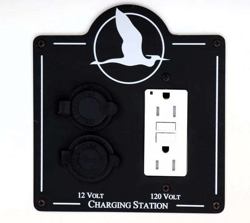 Slide: The Image of Charging station with 12V and 120V outlets on a 2020 Back Cove 34O boat. - 33