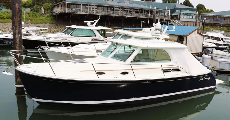 Slide: The Image of 2020 Back Cove 34O boat docked in marina, featuring sleek design and modern amenities. - 4