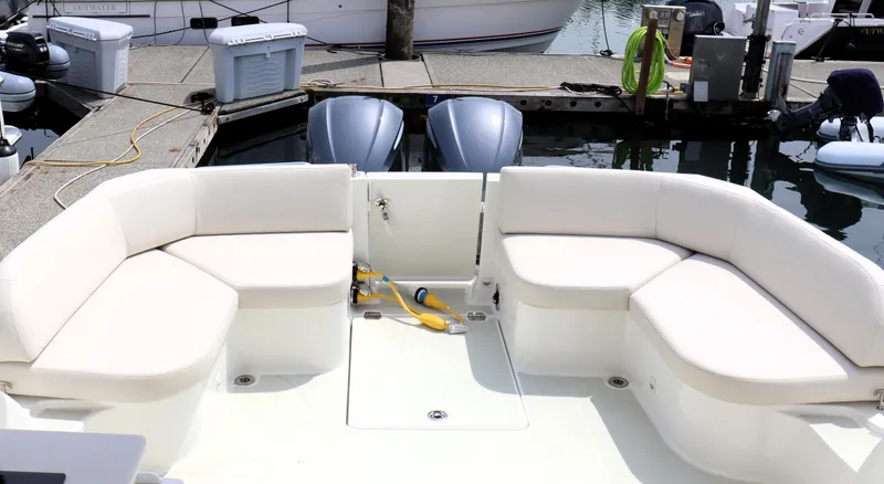 Slide: The Image of 2020 Back Cove 34O boat with spacious white seating at the dock. - 8