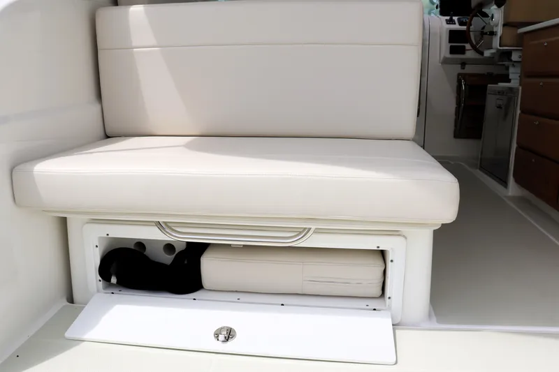 Slide: The Image of 2020 Back Cove 34O boat interior with cushioned seating and storage compartment. - 9
