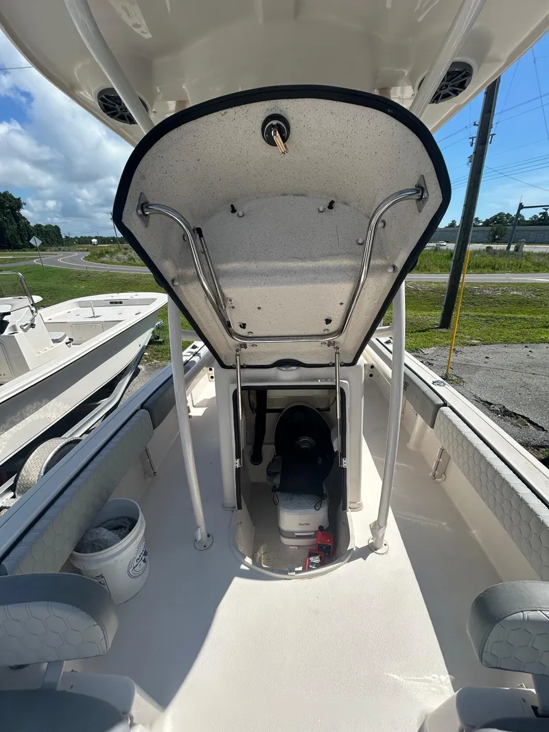 Slide: The Image of 2025 Carolina Skiff 21 Ultra Elite boat interior with open storage compartment. - 3
