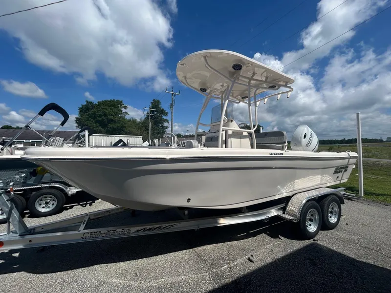Slide: The Image of 2025 Carolina Skiff 21 Ultra Elite boat on trailer under blue sky. - 6
