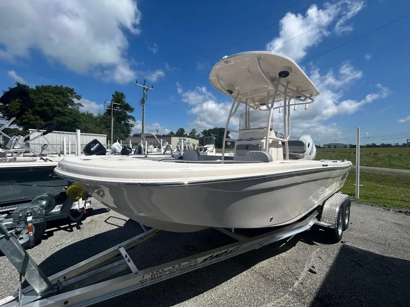 Slide: The Image of 2025 Carolina Skiff 21 Ultra Elite boat on trailer under blue sky. - 7