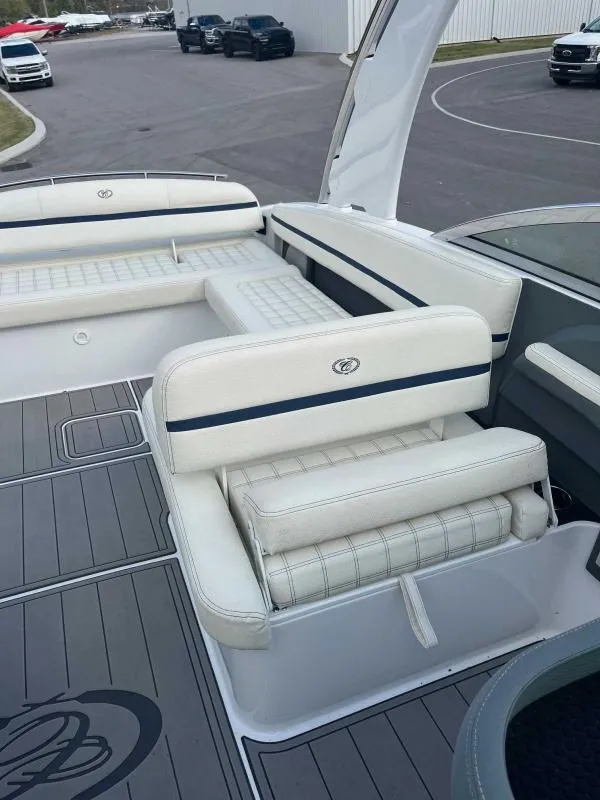 Slide: The Image of 2021 Cobalt R7 boat interior with white cushioned seating and sleek design. - 13