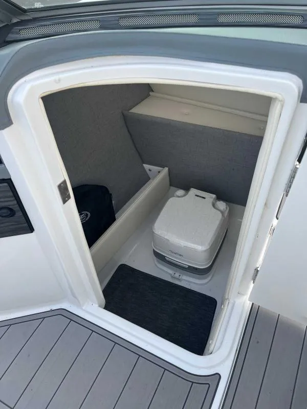 Slide: The Image of 2021 Cobalt R7 boat interior with portable toilet and storage space. - 14