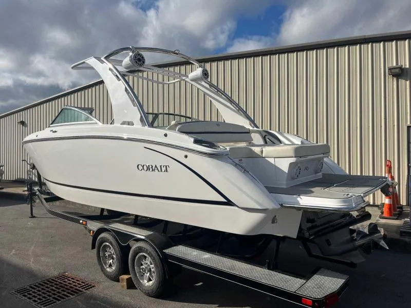 Slide: The Image of 2021 Cobalt R7 boat on trailer, parked outdoors near a metal building. - 5