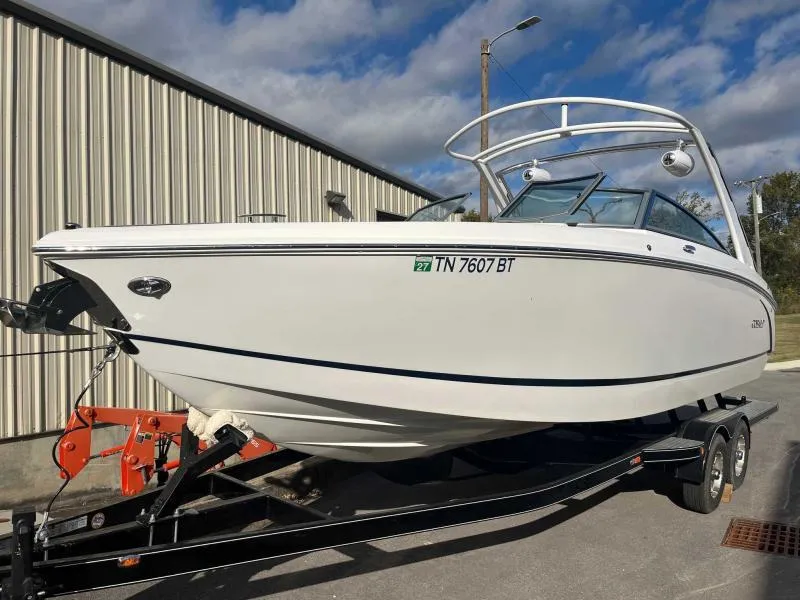 Slide: The Image of 2021 Cobalt R7 boat on trailer, parked outdoors near a metal building. - 6