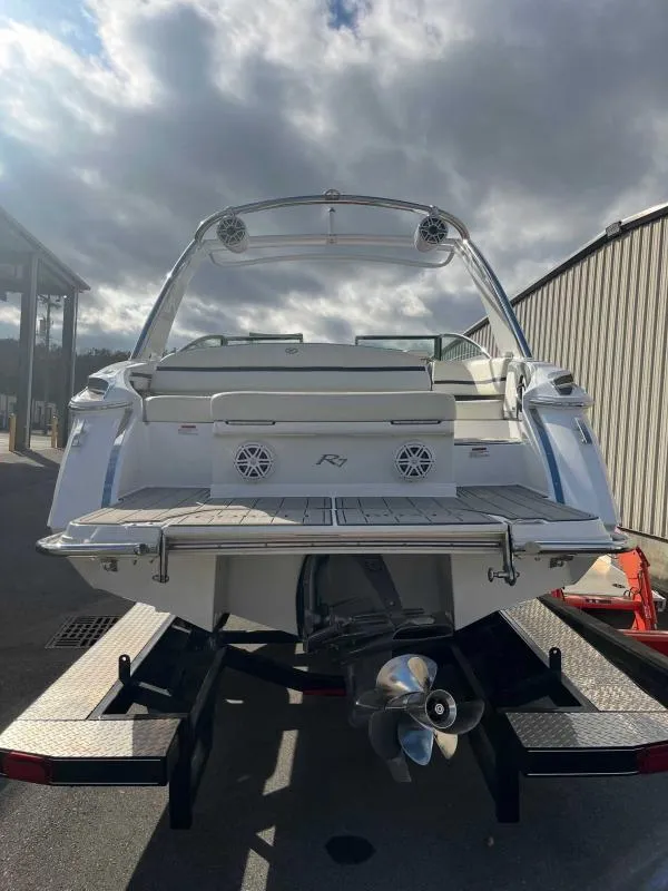 Slide: The Image of 2021 Cobalt R7 boat on trailer, rear view, under cloudy sky. - 8