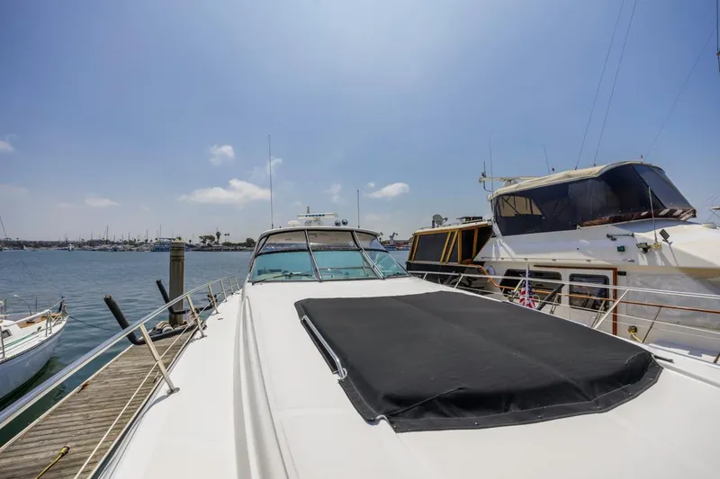 Slide: The Image of 2000 Sea Ray 510 Sundancer yacht docked at marina under clear blue sky. - 11