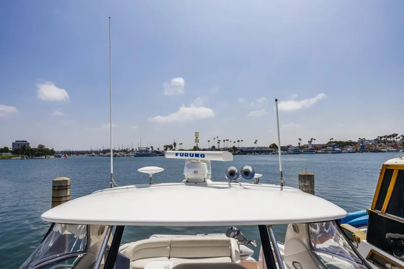 Slide: The Image of Sea Ray 510 Sundancer yacht docked, view of marina and clear sky, 2000 model. - 13