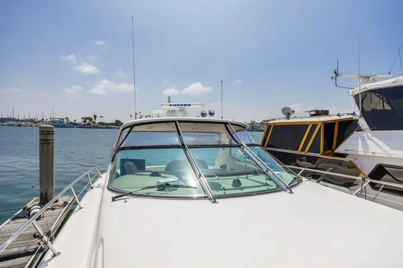 Slide: The Image of Sea Ray 510 Sundancer 2000 yacht docked at marina under clear blue sky. - 17