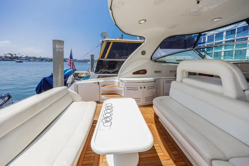 Slide: The Image of Luxurious 2000 Sea Ray 510 Sundancer yacht interior with white seating and wooden deck. - 19