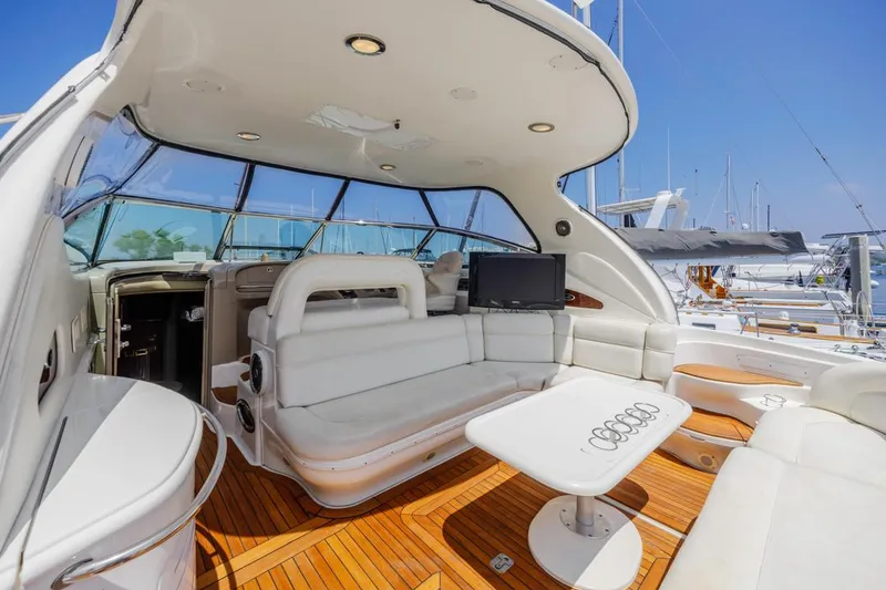 Slide: The Image of Luxurious 2000 Sea Ray 510 Sundancer yacht interior with white seating and wooden flooring. - 22