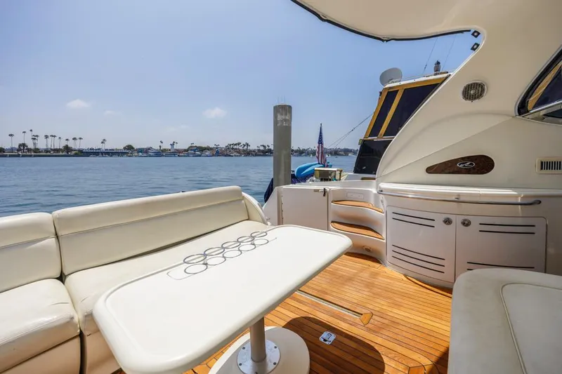 Slide: The Image of Luxurious 2000 Sea Ray 510 Sundancer yacht interior with seating and table, overlooking serene waters. - 24