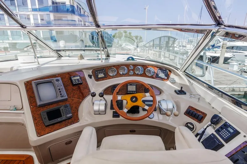 Slide: The Image of Cockpit of 2000 Sea Ray 510 Sundancer yacht with navigation instruments and steering wheel. - 29
