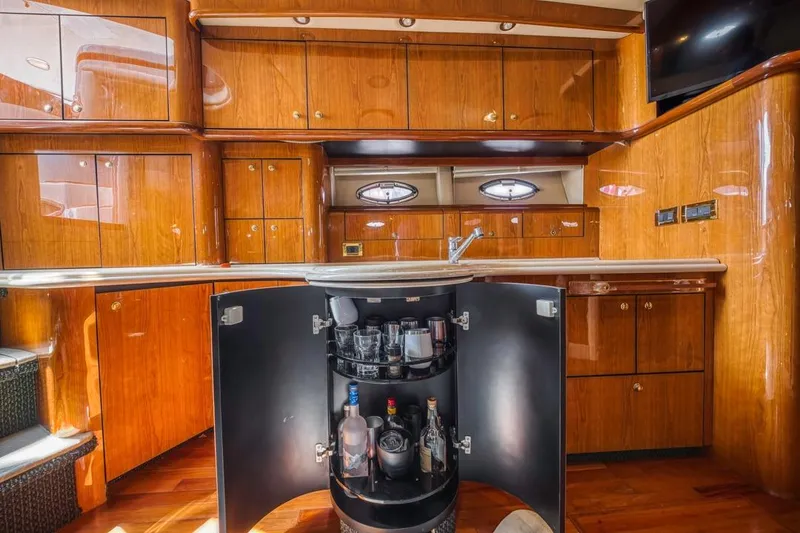 Slide: The Image of Luxurious 2000 Sea Ray 510 Sundancer yacht interior with wooden cabinetry and bar area. - 32