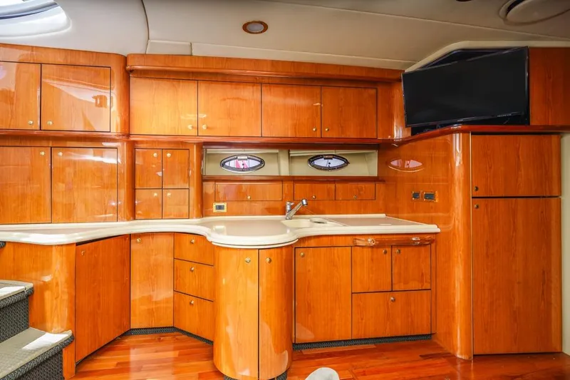 Slide: The Image of Luxurious wooden interior of 2000 Sea Ray 510 Sundancer yacht kitchen area. - 33