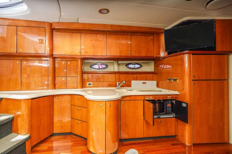 Slide: The Image of Luxurious 2000 Sea Ray 510 Sundancer yacht interior with wooden cabinetry and modern amenities. - 34