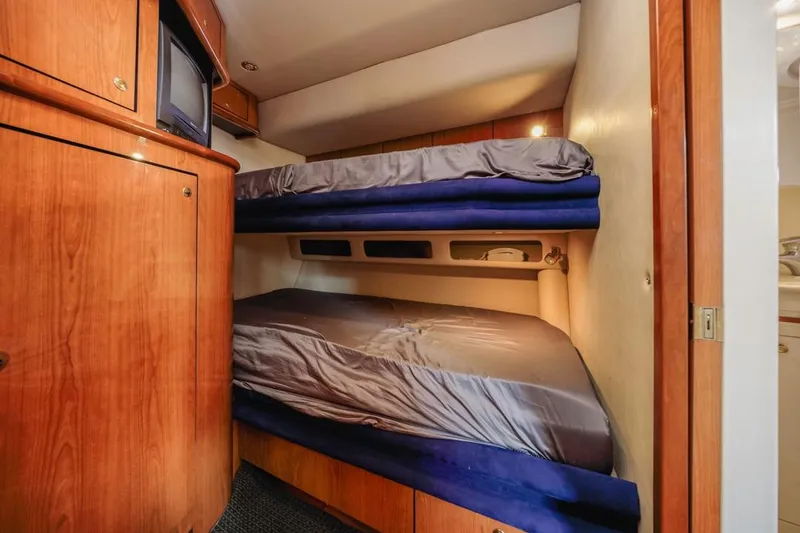 Slide: The Image of Interior of 2000 Sea Ray 510 Sundancer with cozy bunk beds and wooden cabinetry. - 38