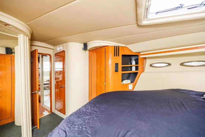 Slide: The Image of Luxurious interior of 2000 Sea Ray 510 Sundancer yacht with wood accents and portholes. - 41