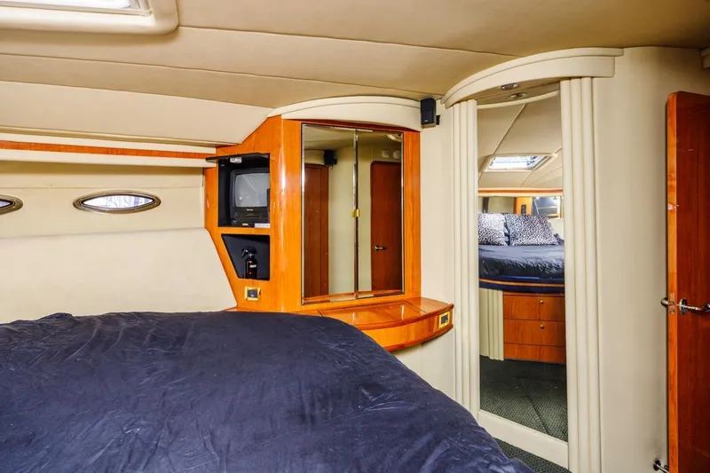 Slide: The Image of Interior of 2000 Sea Ray 510 Sundancer yacht with cozy bedroom and wooden accents. - 42