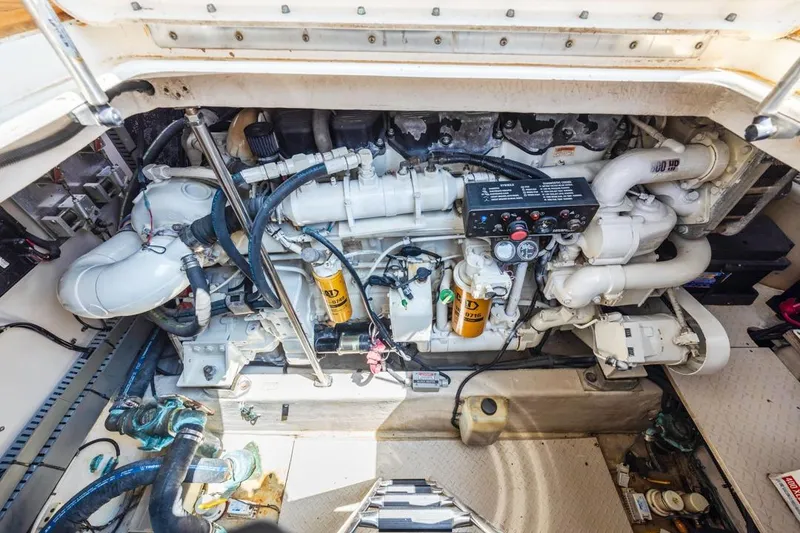 Slide: The Image of Engine compartment of a 2000 Sea Ray 510 Sundancer yacht, showcasing mechanical components. - 48