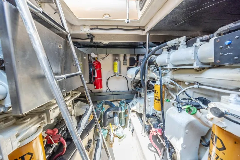 Slide: The Image of Engine room of 2000 Sea Ray 510 Sundancer with visible machinery and fire extinguisher. - 49