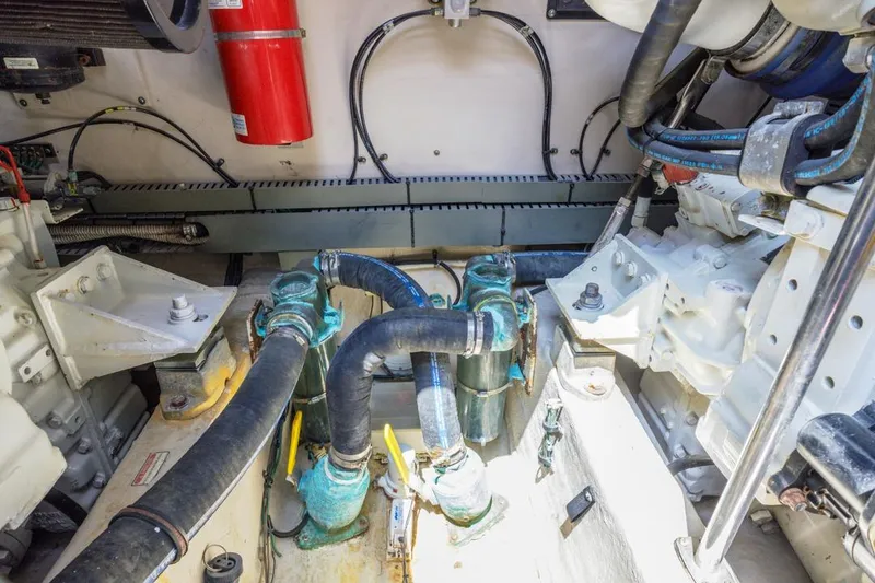 Slide: The Image of Engine room of 2000 Sea Ray 510 Sundancer with visible hoses and fire extinguisher. - 50