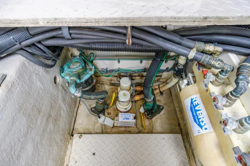 Slide: The Image of Engine compartment of a 2000 Sea Ray 510 Sundancer with visible hoses and Reverso oil system. - 51