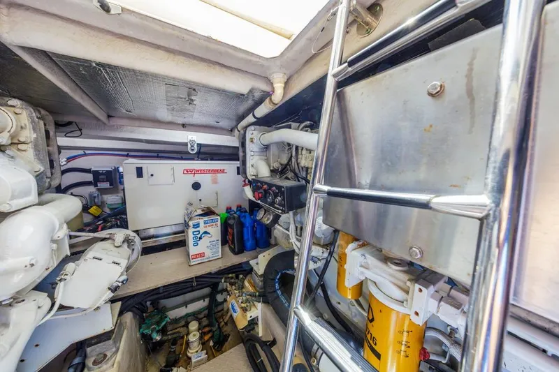 Slide: The Image of Engine room of 2000 Sea Ray 510 Sundancer with equipment and maintenance supplies. - 55