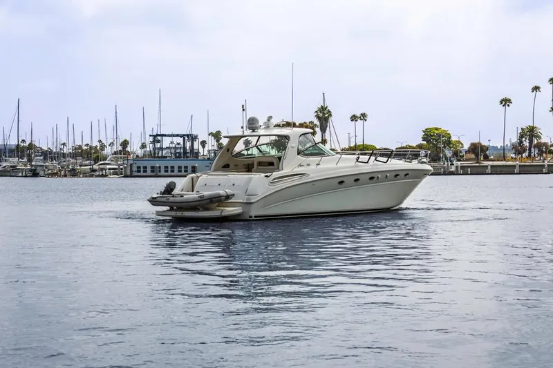 Slide: The Image of 2000 Sea Ray 510 Sundancer yacht docked in a marina with palm trees. - 6
