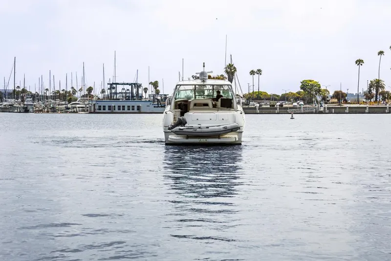 Slide: The Image of Sea Ray 510 Sundancer yacht from 2000 cruising in a marina with palm trees. - 8