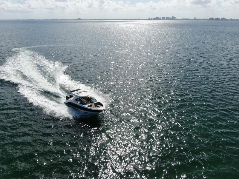 Slide: The Image of 2018 Sea Ray 310 SLX cruising on sparkling ocean waters under a sunny sky. - 16