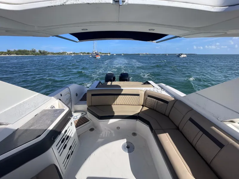 Slide: The Image of 2018 Sea Ray 310 SLX boat interior with seating, cruising on open water. - 17