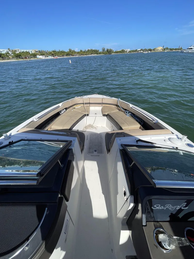 Slide: The Image of 2018 Sea Ray 310 SLX boat on water, featuring spacious seating and sleek design. - 19