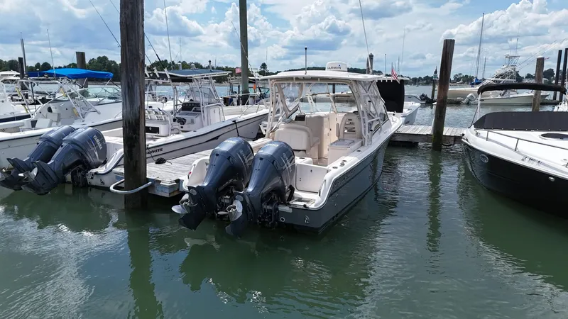 Slide: The Image of 2017 Grady-White Freedom 275 boat docked with twin outboard engines. - 2