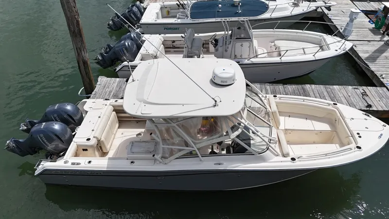 Slide: The Image of 2017 Grady-White Freedom 275 boat docked with twin outboard engines. - 3