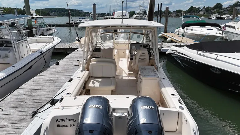 Slide: The Image of 2017 Grady-White Freedom 275 boat docked at marina with twin Yamaha engines. - 6