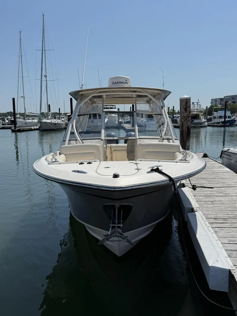 Slide: The Image of 2017 Grady-White Freedom 275 boat docked in marina, clear sky background. - 7