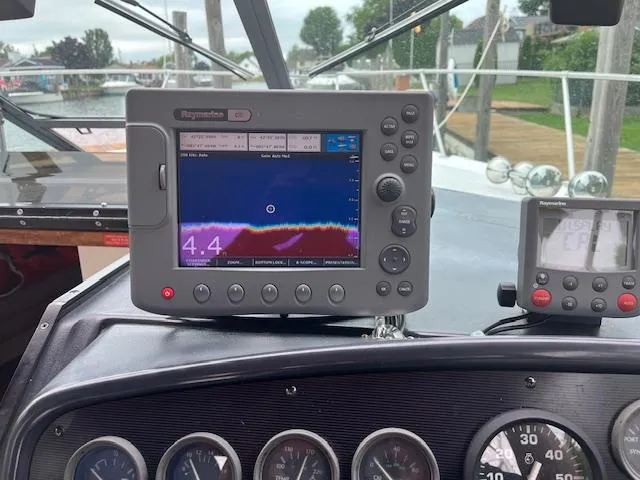 Slide: The Image of Dashboard of a 1992 Sea Ray 310 Amberjack with navigation equipment. - 10