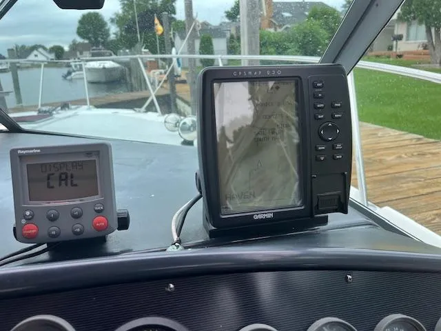 Slide: The Image of Control panel of a 1992 Sea Ray 310 Amberjack with navigation equipment. - 11