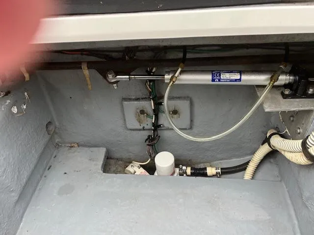 Slide: The Image of Engine compartment of 1992 Sea Ray 310 Amberjack boat, showing hydraulic and electrical components. - 22