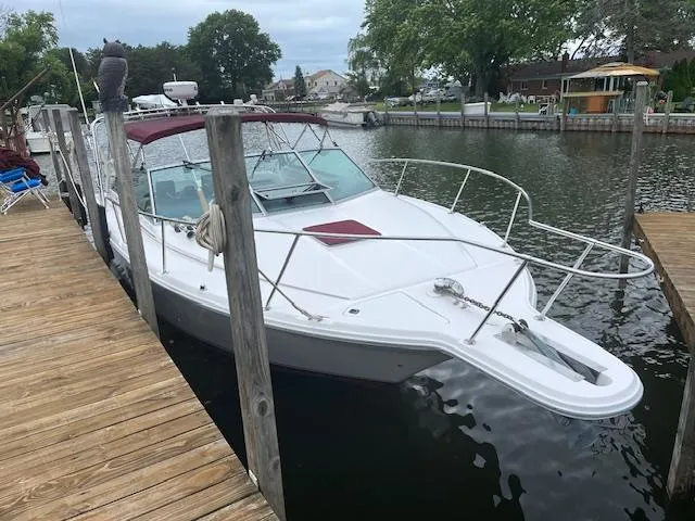 Slide: The Image of 1992 Sea Ray 310 Amberjack docked at a marina, featuring a sleek white design. - 3