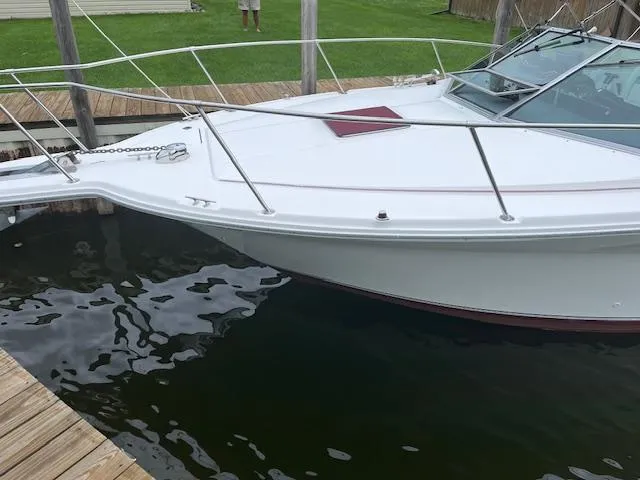 Slide: The Image of 1992 Sea Ray 310 Amberjack docked in a marina, showcasing sleek white hull design. - 5