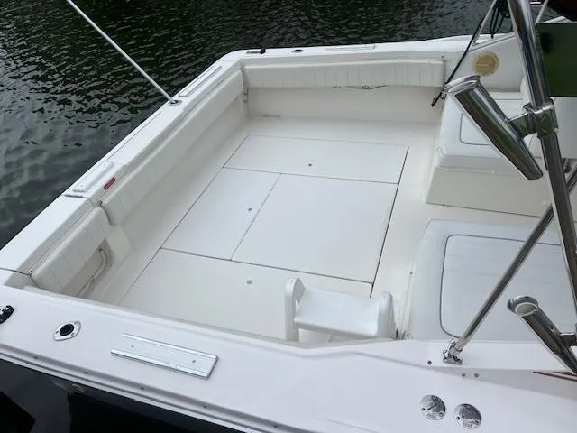 Slide: The Image of 1992 Sea Ray 310 Amberjack boat deck, spacious and clean, docked by the water. - 6