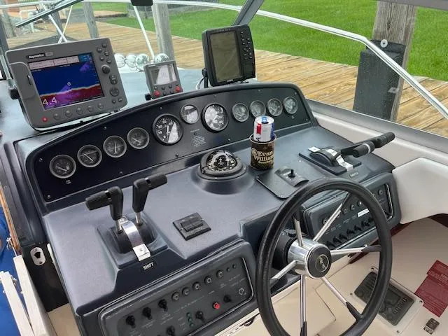 Slide: The Image of Control panel of a 1992 Sea Ray 310 Amberjack boat with navigation instruments. - 9