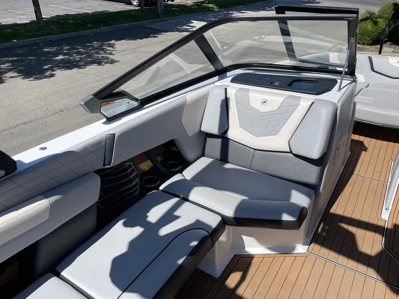 Slide: The Image of 2021 Nautique Super Air Nautique G25 interior with luxurious seating and sleek design. - 10