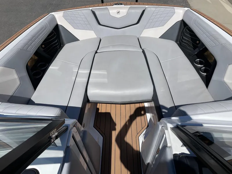 Slide: The Image of 2021 Nautique Super Air Nautique G25 boat interior with luxurious seating and cup holders. - 11