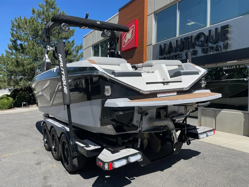 Slide: The Image of 2021 Nautique Super Air Nautique G25 boat on trailer outside dealership. - 3